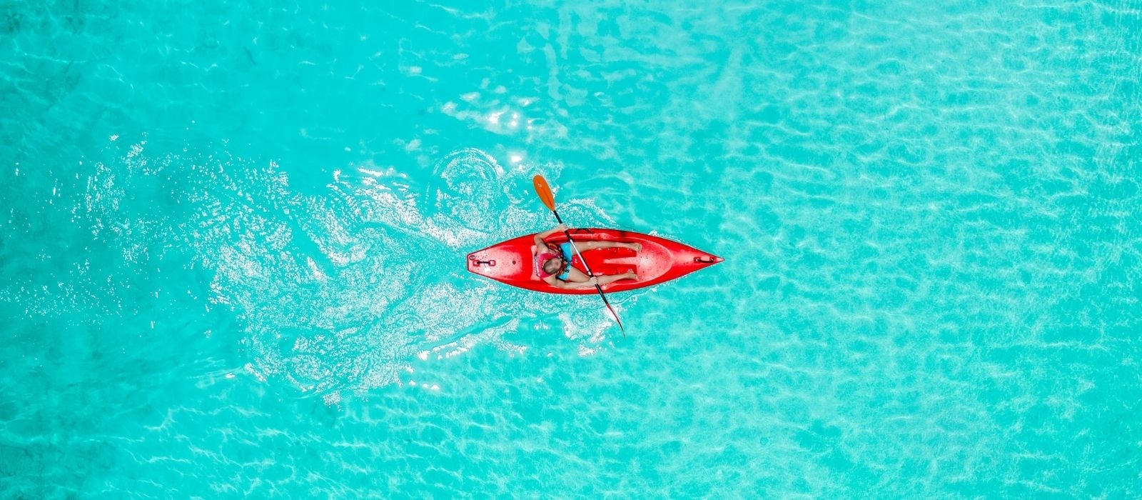 person rowing a kayak in the water